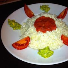 Cauliflower "rice" with tomato & date sauce at avocado & herbs cream.

I chopped the cauliflower with my blender at low speed, made a sweet and delicious sauce out of some tomatoes and dates and finally made a thick cream out of an avocado halve, some Italian herbs and a tiny bit of pure water.