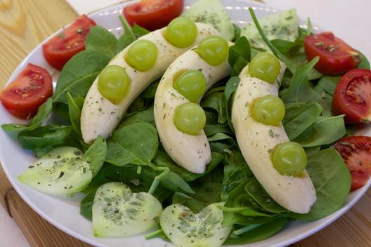 Grapes on bananas at baby spinach