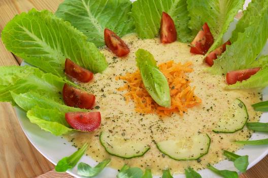 Pineapple - apple - soup with carrots on romaine lettuce 