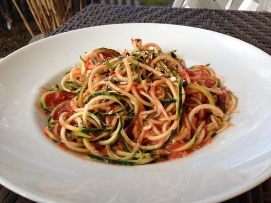 Zucchini noodles with a very tasty sauce of tomatoes, a small piece of yellow pepper and some pumpkin seeds