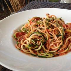 Zucchini noodles with a very tasty sauce of tomatoes, a small piece of yellow pepper and some pumpkin seeds